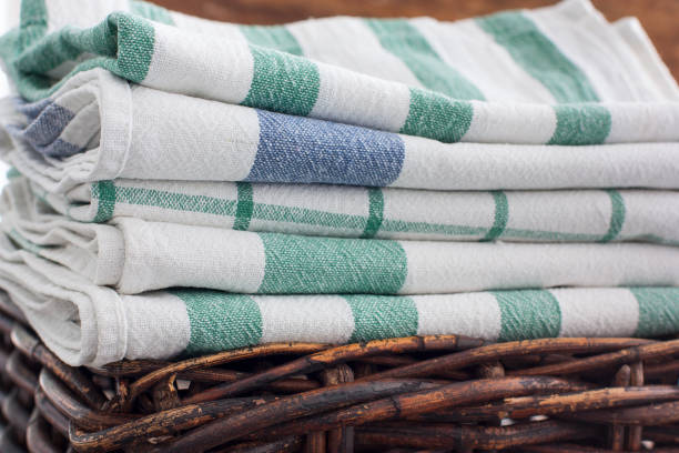 istock Clean kitchen towels stacked in a basket on the basket, selective focus 1057931746