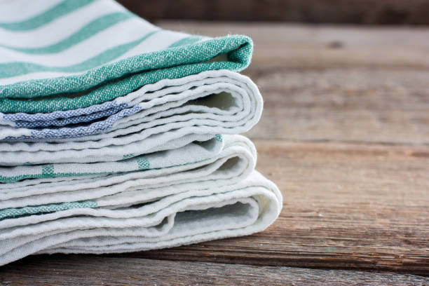 istock Clean kitchen towels stacked in a basket on the basket, selective focus 1057931814