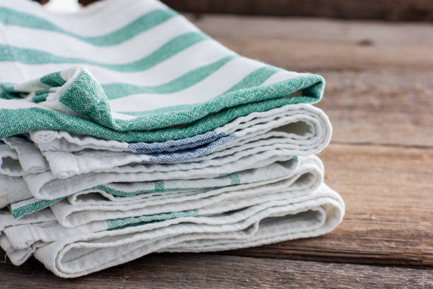 istock Clean kitchen towels stacked in a basket on the basket, selective focus 1057931826