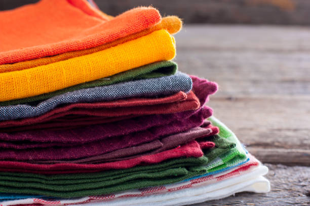 istock Colored linen napkins on a wooden table, copy space 1057931864