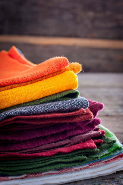 istock Colored linen napkins on a wooden table, copy space 1057932024