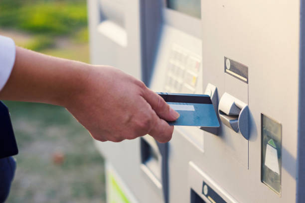 Hand inserting ATM credit card stock photo