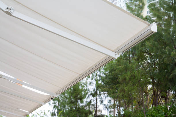 istock new white awning in green garden background. 1057936074
