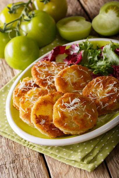 istock American crispy fried green tomatoes with fresh lettuce close-up on a plate. vertical 1057938664