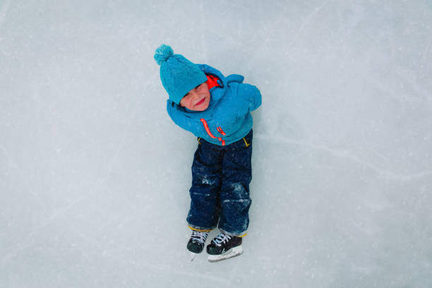 istock cute little boy enjoy skating in winter 1057939032