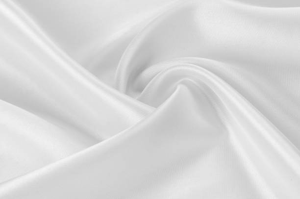 istock Texture, background, pattern. White silk fabric, Smooth elegant white silk or satin fabric fabric can be used as a wedding background. Luxury Christmas background or New Year background design 1057939292