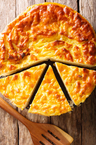 istock rice pie with ricotta cheese, eggs and sugar close-up. Vertical top view from above 1057939582