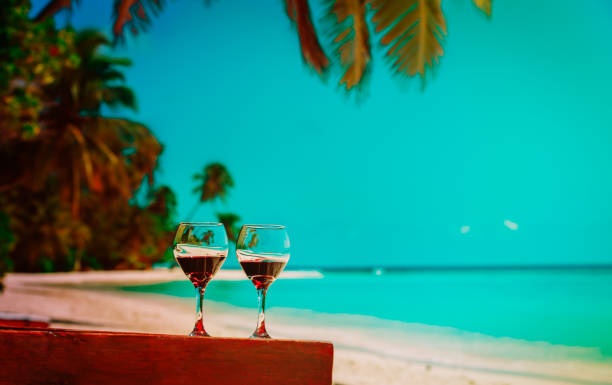 istock two wine glasses on tropical sand beach vacation 1057941404