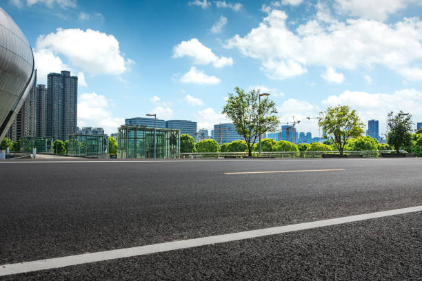 istock long empty footpath in modern city square with skyline. 1057943044