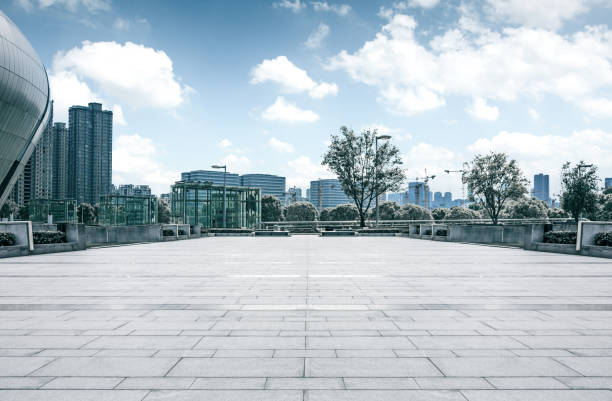 istock long empty footpath in modern city square with skyline. 1057943104