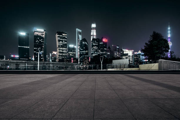 istock Empty floor with modern skyline and buildings at night in Shanghai 1057944034