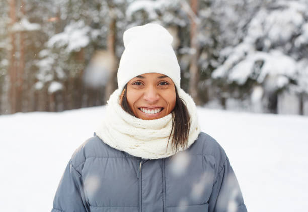 istock Mixed race girl under falling snow 1057945434