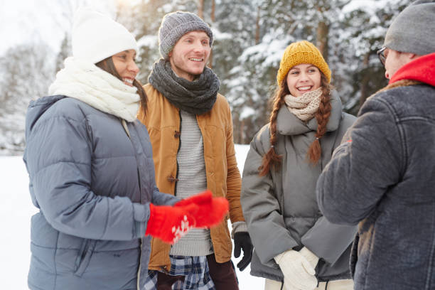 istock Excited friends chatting in winter forest 1057945440