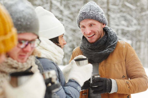 istock Friends talking and drinking tea from thermos 1057945502