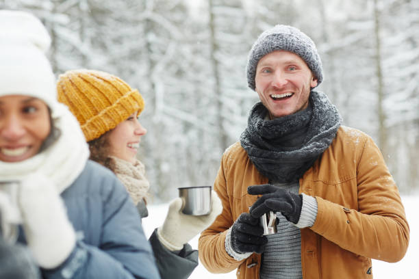 istock Young friends drinking hot tea to get warm 1057945522