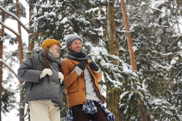 istock Excited friends with backpacks in winter forest 1057945666