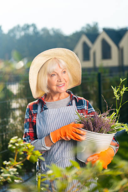 istock Smiling pretty old woman spending a day outside 1057947312