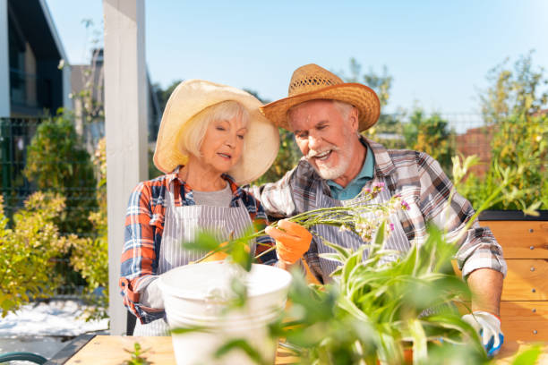 istock Caring loving husband hugging his wife while looking at field plants 1057949752