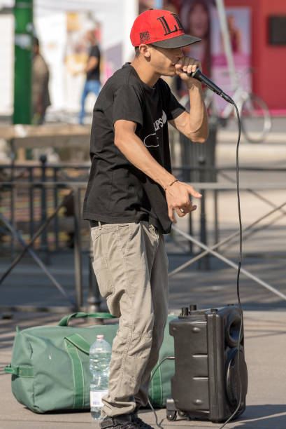 Street Performer of Beatbox in Milan Italy Milan, Italy - September 24th, 2016: A boy beatbox performs in a street of the city center of Milan (Milano). The Beatboxing (also beat boxing or b-boxing) is a form of vocal percussion involving the art of mimicking drum machines using one's mouth, lips, tongue, and voice. dubstep photos stock pictures, royalty-free photos & images