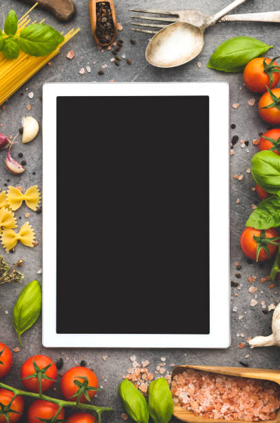 istock Digital tablet with ingredients for cooking Italian pasta 1057951064