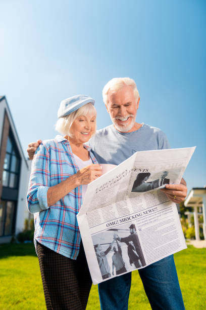 istock Man and woman leaving their private house while reading newspaper 1057952994