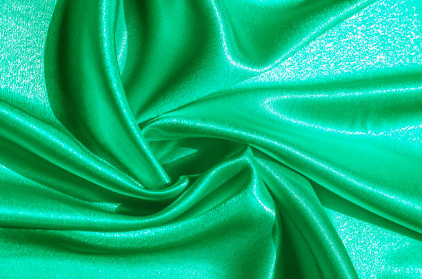 istock Texture, fabric, background. Abstract background of luxurious fabric or liquid waves or wavy grunge crease silk satin texture of velvet material or luxurious Christmas or elegant background. green 1057958404
