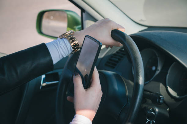 istock Woman In car using phone 1057962488