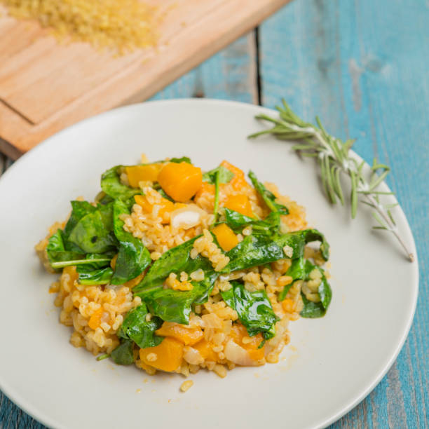 istock Bulgur with pumpkin and cutting board with ingredients 1057963228
