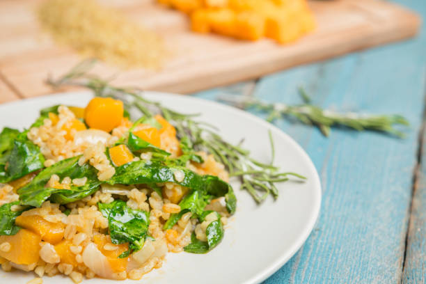 istock Bulgur with pumpkin and cutting board with ingredients 1057963250