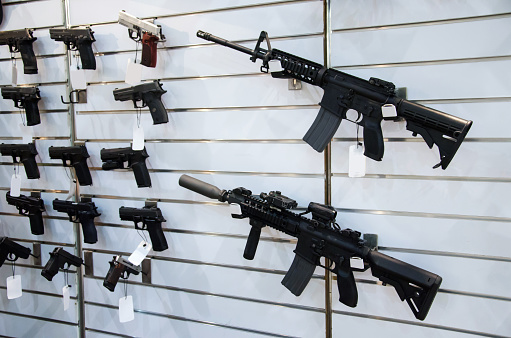 Gun wall rack with rifles and pistol.