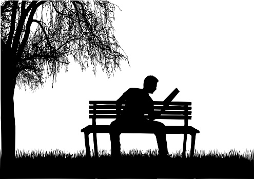 Silhouette of a man with a book.