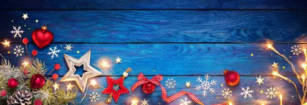 Christmas Baubles On Blue Plank With Light