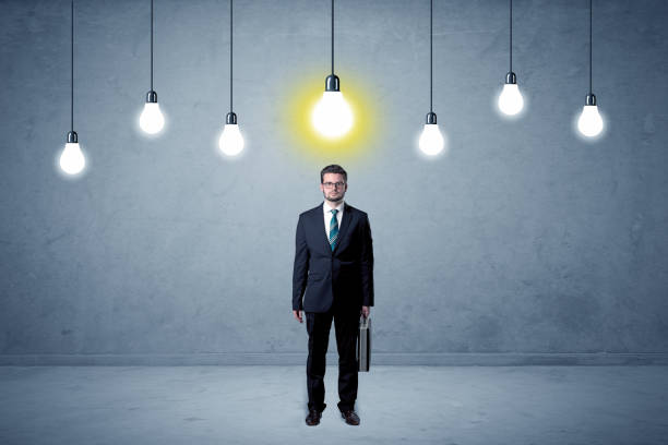 istock Businessman standing uninspired with bulbs above 1057967856