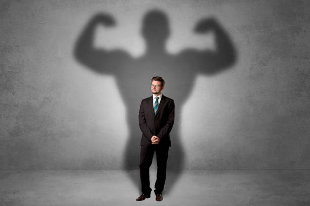 istock Businessman with muscular shade behind his back 1057967984