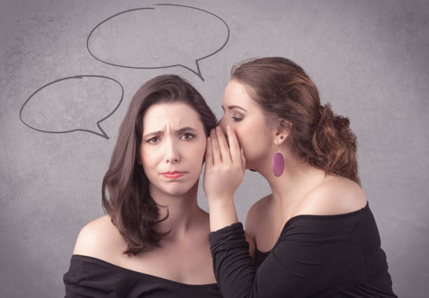 istock girl telling secret things to her girlfriend 1057971074