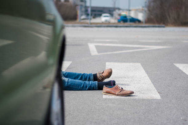 istock Traffic accident. Young man hit by a car 1057971080