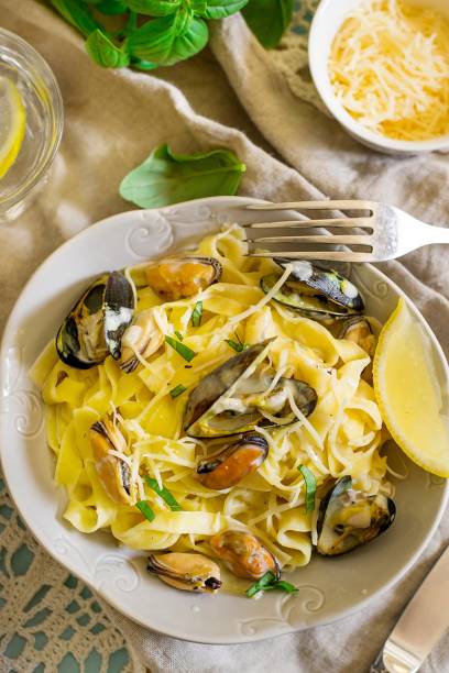 istock Tagliatelle pasta with mussels in creamy sauce and basil 1057971120