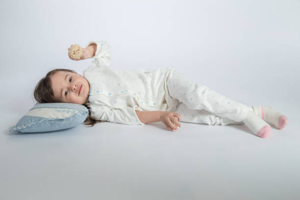 istock girl sleeping in bed at home 1057971326