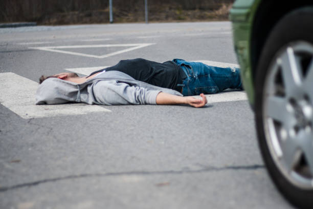 istock Traffic accident. Young man hit by a car 1057971514