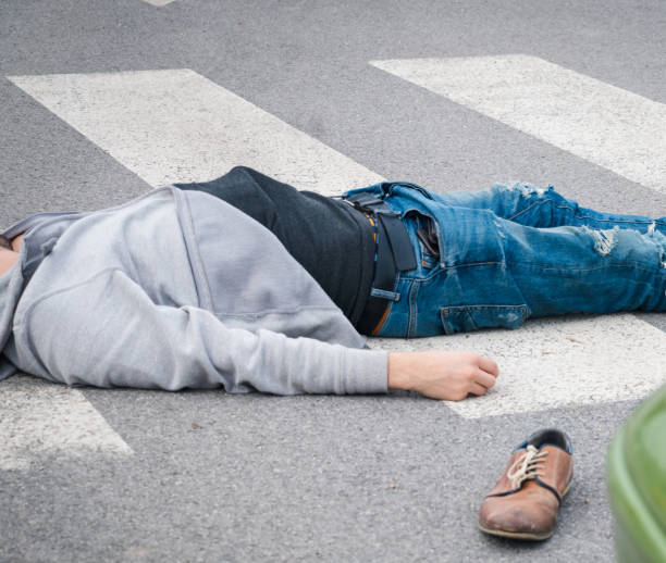 istock Traffic accident. Young man hit by a car 1057972906