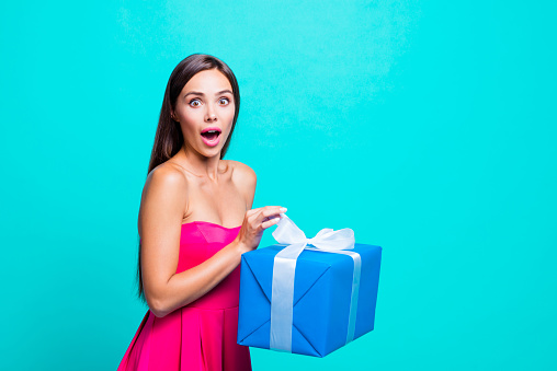 It's absolutely free! Close up studio photo portrait of amazed wondered astonished crazy mad with pop eyes lady opening giftbox in hands isolated on bright vivid background