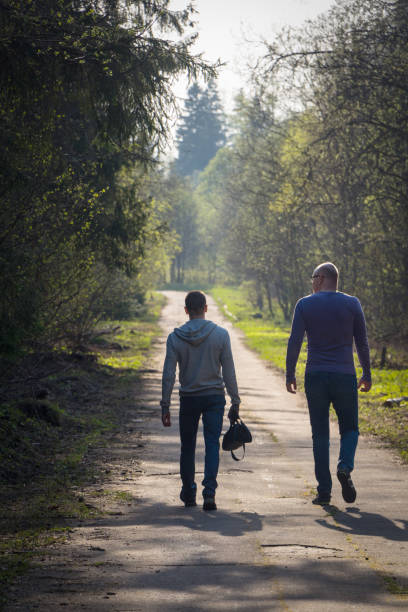 istock Two friends walk in the park, big and small concept 1057974644