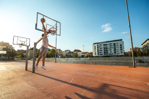 istock Basketball Player Scoring With Slam Dunk 1057980586
