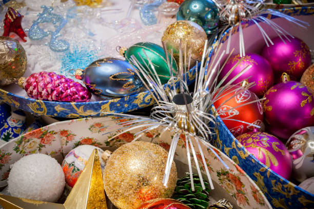 istock Close-up bright colorful Christmas decorations in open round boxes. 1057981024