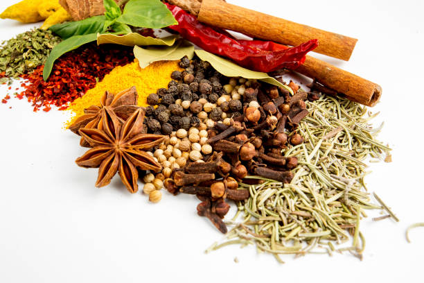 istock Top view mix spices and herbs different size terracotta pots on white background with copy space for design vegetables, healthy lifestyle, spices, herbs or foods content. 1057981246