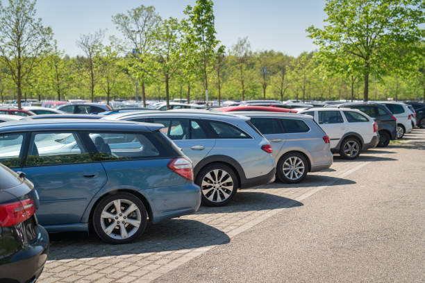 row of cars in parking lot stock photo
