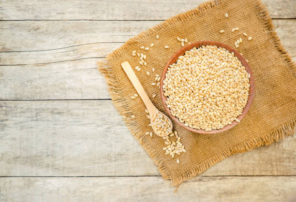 istock Pearl barley in teralke on the table. Selective focus. 1057989330