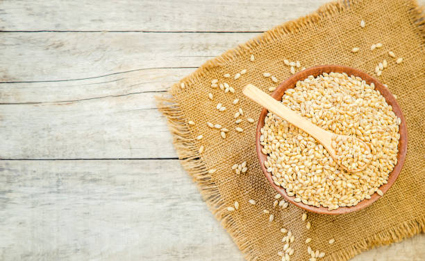 istock Pearl barley in teralke on the table. Selective focus. 1057989338