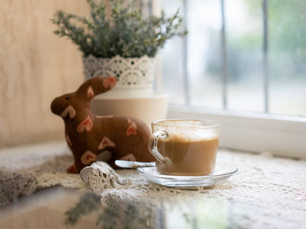 cup of coffee on the windowsill mug of coffee is on the windowsill next to the flower pot кружка stock pictures, royalty-free photos & images