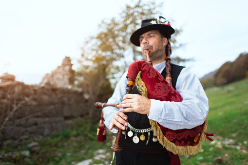 Typical player in traditional bergamo bagpipe from the alpine valleys of northern Italy